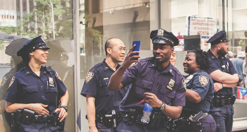 powerdms-assets-photos-040-officer-taking-iphone-photo-on-duty
