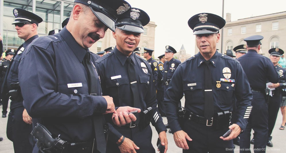 powerdms-assets-photos-056-cops-using-cell-phone