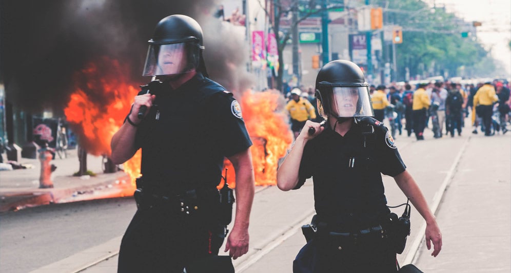 powerdms-assets-photos-062-cops-riot-gear-fire