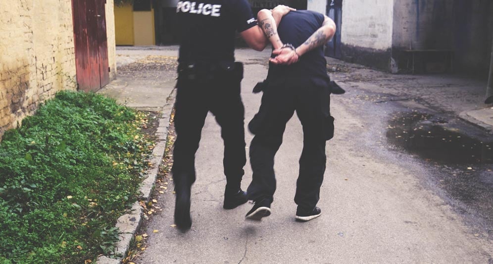 powerdms-assets-photos-065-cop-arresting-man