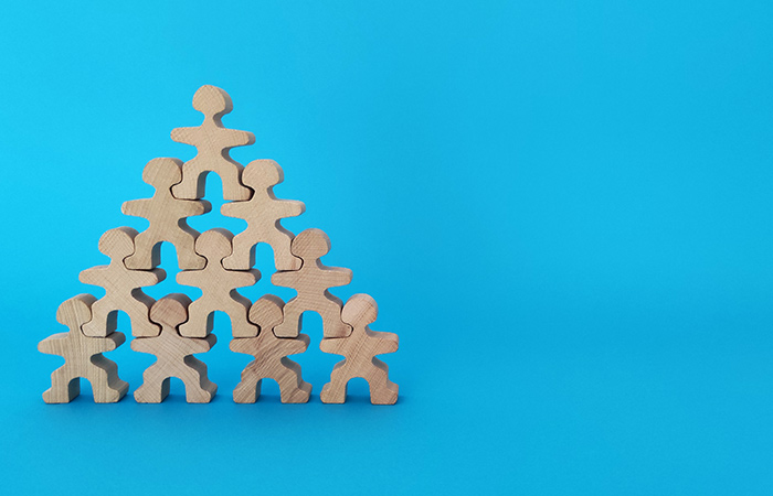 wooden figures stacked in pyramid