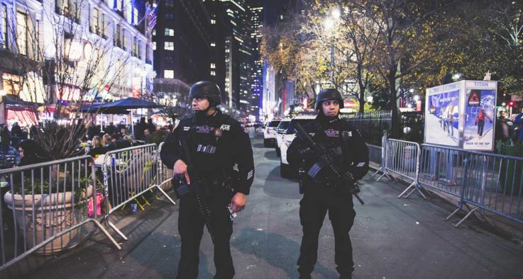 two police officers working night shift crowded street