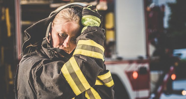 firewoman removing her helmet