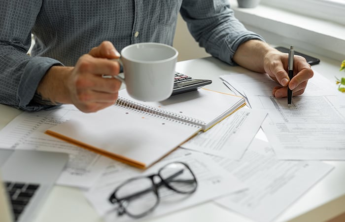 Coffee cup on top of notebook