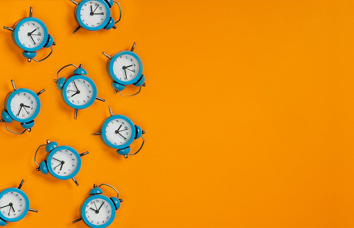 Blue clocks with an orange background