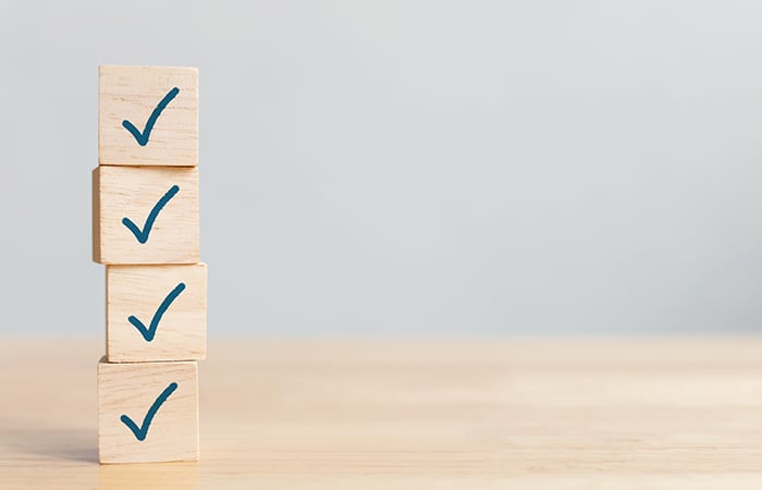 Stacked wooden blocks with checkmarks on them