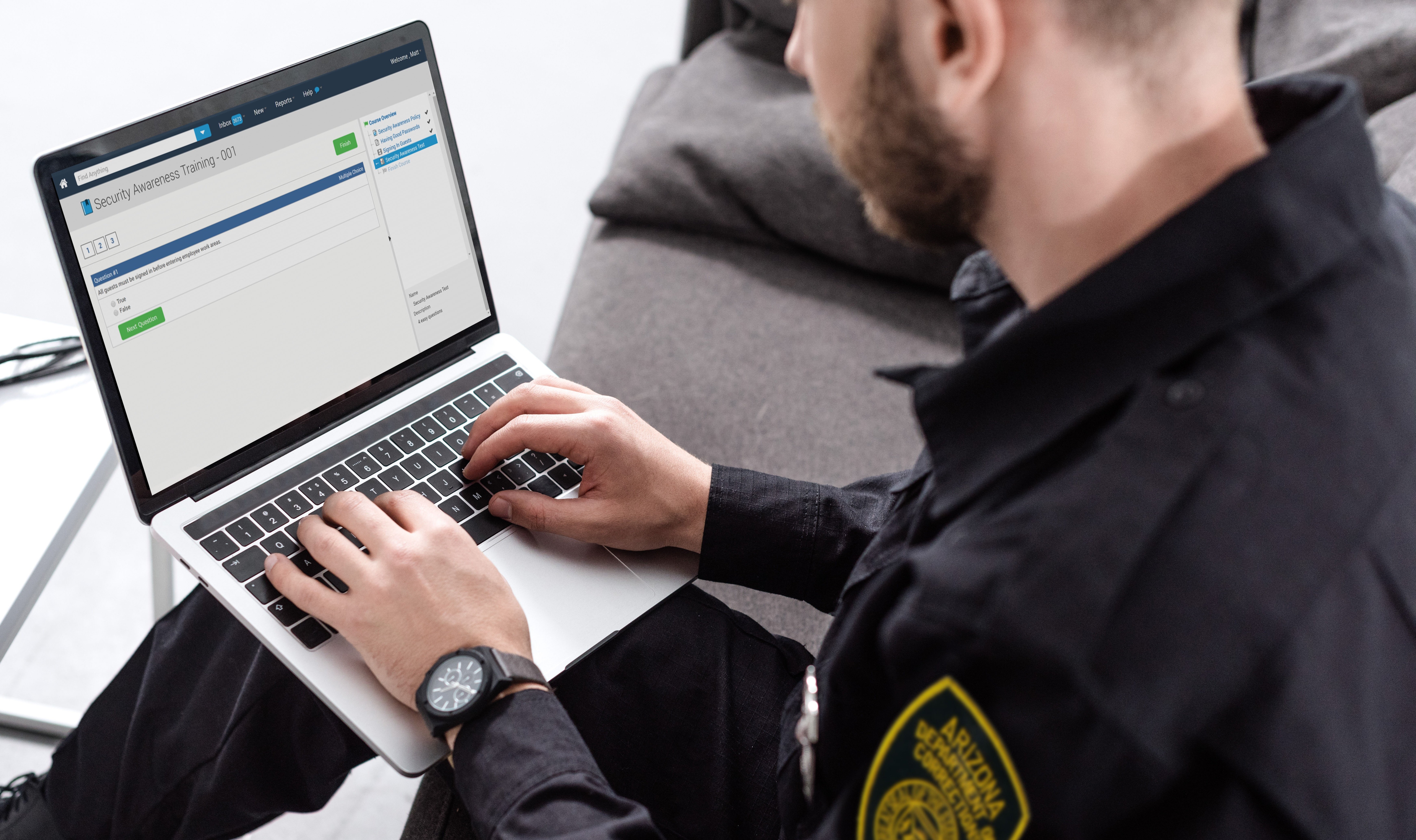 law enforcement officer completing a digital training on a computer