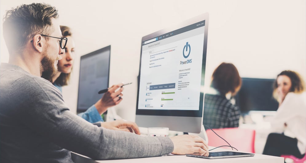 two-people-using-computer-powerdms-app-on-screen