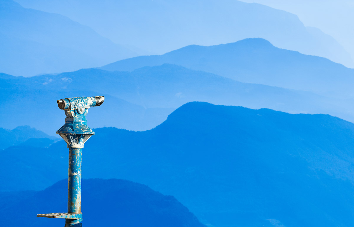 coin binoculars overlooking mountains