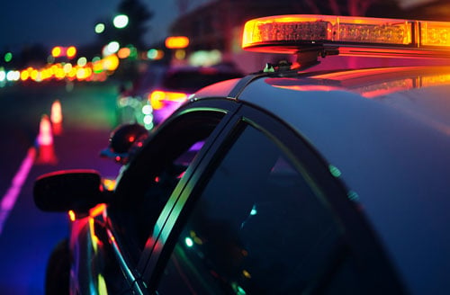 police car driving at night