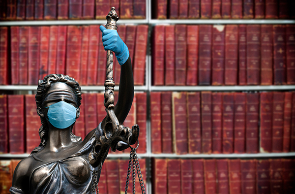 lady justice statue wearing mask and gloves 