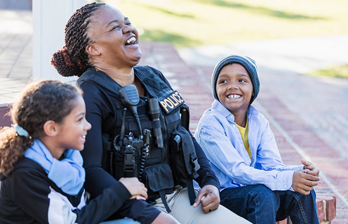 female police officer laughing with children