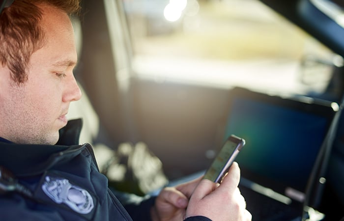 Officer looking at cell phone