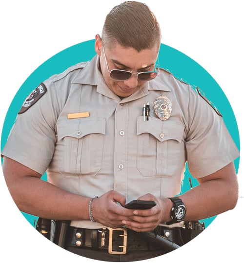police officer looking down at cell phone learning new policies